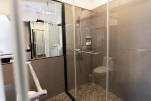 a bathroom with a glass shower with a toilet at Stay Inn in Taipei +31 photos