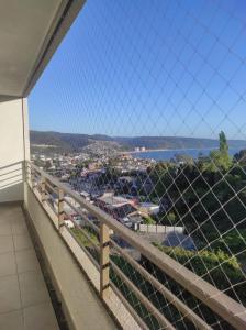 a view of a city from a balcony at Depto. con vista al mar 4° piso, Tomé, Dichato in Tomé