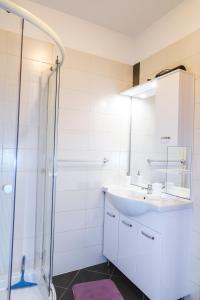 a bathroom with a sink and a shower at Apartments Mirela in Koper +21 photos