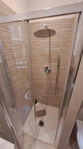 a shower with a glass door in a bathroom at La casetta in Cuneo