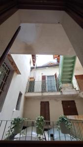 a view of a building with a balcony with plants at La casetta in Cuneo