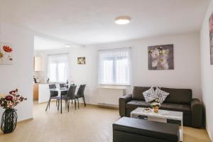 a living room with a couch and a table at Apartments Mirela in Koper