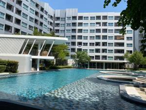 a swimming pool in front of a building at Elio Del Ray in Bangkok