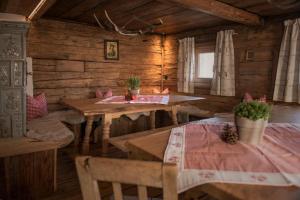 a dining room with tables and chairs in a cabin at Wildauhof - Alm in Fügenberg