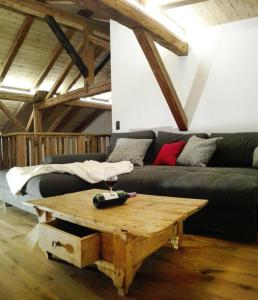 a living room with a couch and a wooden coffee table at Wildauhof - Alm in Fügenberg