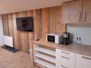 a kitchen with a microwave on top of a counter at Wildauhof - Bauernhaus in Fügenberg