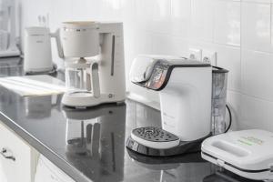 a kitchen with a counter with a coffee maker on it at Alpha & Omega in Karpathos Town