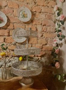 a metal stand with plates on a brick wall at Lilla Brunn in Stockholm +126 photos