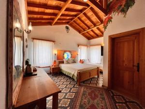 a bedroom with a bed and a wooden ceiling at Eski Datça Otel in Datca