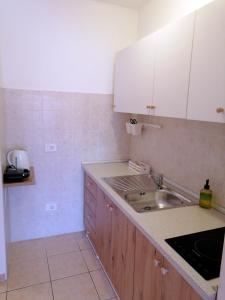 a kitchen with a sink and a counter top at Apartment Suzie Q - Intermezzo with sea view in Rabac