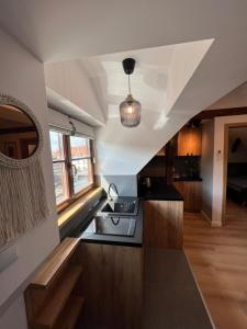 a kitchen with a sink and a counter top at Apartament Miasteczko in Kazimierz Dolny