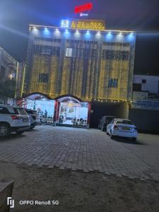 a large building with cars parked in a parking lot at OYO Flagship Hotel Amarpali in Baddi