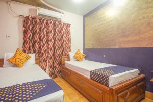 Krevet ili kreveti u jedinici u okviru objekta OYO Hotel Chitra