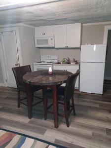 a kitchen with a table and chairs and a refrigerator at Cute 1 Bdrm House that sleeps 3 in Petersburg