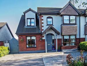 a red brick house with a blue door at Sleepy Rock in Dungarvan