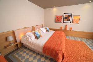 a bedroom with a large bed with an orange blanket at Château de Valmy - Chambres d'hôtes in Argelès-sur-Mer +29 photos