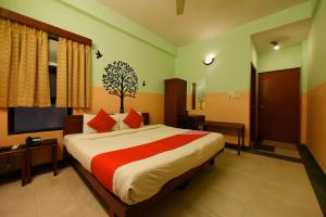 a bedroom with a large bed with red pillows at Collection O Hotel Blue Bird in Jaipur