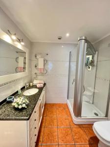 a bathroom with a shower and a sink at Cocas House - Alcobaça in Alcobaça