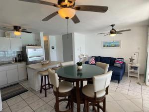 a kitchen and living room with a table and a couch at Oceanfront Condo in Luquillo in Luquillo