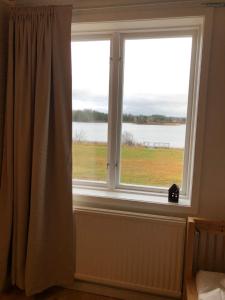 a window with a view of the water at Anna Gården, App. D in Ytterhogdal