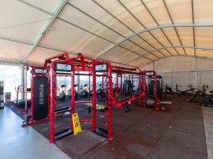 a gym with red equipment in a tent at Sun city lifestyle in Poreč