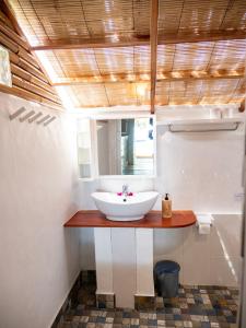 a bathroom with a sink and a mirror at Seaside Cottage, Gili Air in Gili Air