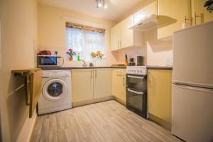 a kitchen with a washing machine and a washer at 7 Berth Chalet In Hemsby In Norfolk By The Beautiful Golden Beach Ref 18165b in Hemsby