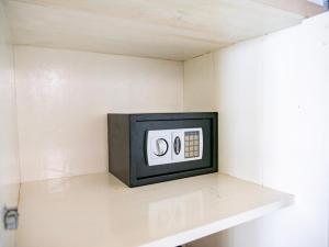 a small tv sitting on a shelf in a room at Seaside Cottage, Gili Air in Gili Air