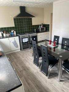 a kitchen with a table and chairs and a stove at Winmar in Inverness