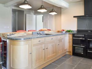 a kitchen with a sink and a stove at Souterstead in Torver