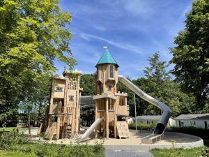 a playground in a park with a water slide at Camping Fuussekaul in Heiderscheid