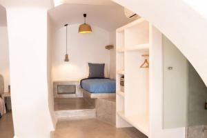 a bedroom with a bed in a white room at Traditional Arch House Paros in Márpissa
