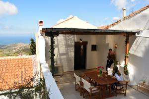 a woman standing on the patio of a house at The twins house in Samothraki