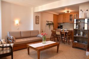 a living room with a couch and a table at The twins house in Samothraki