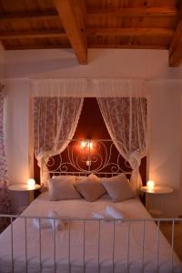 a bedroom with a bed with a headboard and two lamps at The twins house in Samothraki