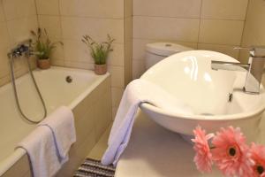 a bathroom with a tub and a toilet and a sink at The twins house in Samothraki