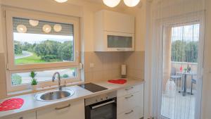a kitchen with a sink and a window at Sea & Sun 4* in Banjole
