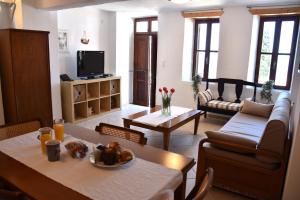 a living room with a table and a couch at The twins house in Samothraki