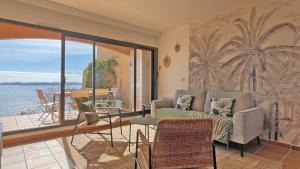 a living room with a couch and a view of the ocean at Clos de la Madrague in Sainte-Maxime