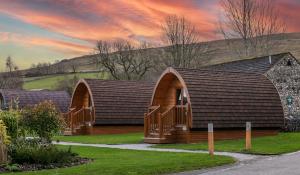 a house with a pitched roof with a porch at Littondale Country & Leisure Park in Skipton
