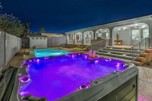 a swimming pool with purple lighting in a backyard at Chateau Desert Oasis minutes from Vegas Strip in Las Vegas
