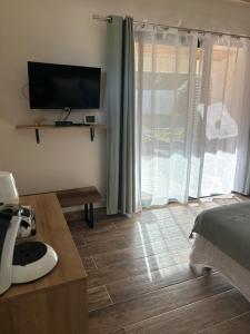 a bedroom with a bed and a television on a wall at Résidence Alba in Bonifacio