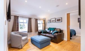 a living room with a couch and a chair at Barn End in Ambleside