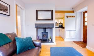 a living room with a couch and a fireplace at Barn End in Ambleside