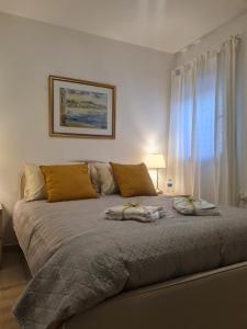 a bedroom with a large bed with two animals on it at A Dream Place in Raanana, Spacious & Luxurious Apartment up to 4 guests - Swimming Pool in Ra‘ananna