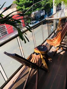 two chairs and a surfboard sitting on a balcony at Hotel Ko'ox Wenne in Tulum