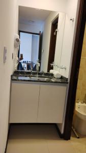 une salle de bain avec un lavabo et un miroir et des toilettes dans l'établissement Veneto Village, Complejo Vacacional, à Villa Parque Siquiman