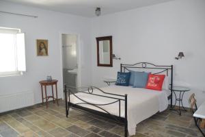 - une chambre avec un lit doté d'oreillers rouges et bleus dans l'établissement Sea view studio 2, à Batsi