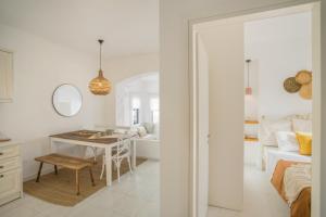 a white room with a table and a bedroom at Piperi-2 Bedroom home in Naousa