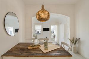 a dining room with a wooden table and a mirror at Piperi-2 Bedroom home in Naousa